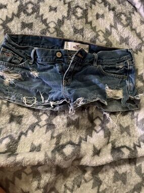 Hollister Women's Distressed Denim Cutoff Shorts in Dark Blue Wash